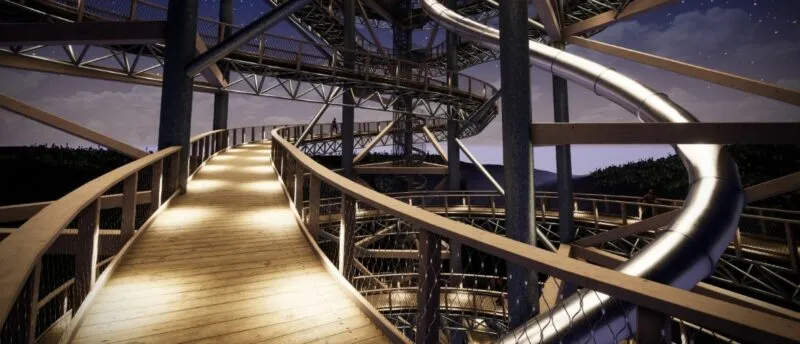 Oświetlona drewniana kładka Sky Walk w Świeradowie-Zdroju wije się nocą wśród stalowej konstrukcji wieży, obok szerokiej, spiralnej zjeżdżalni.