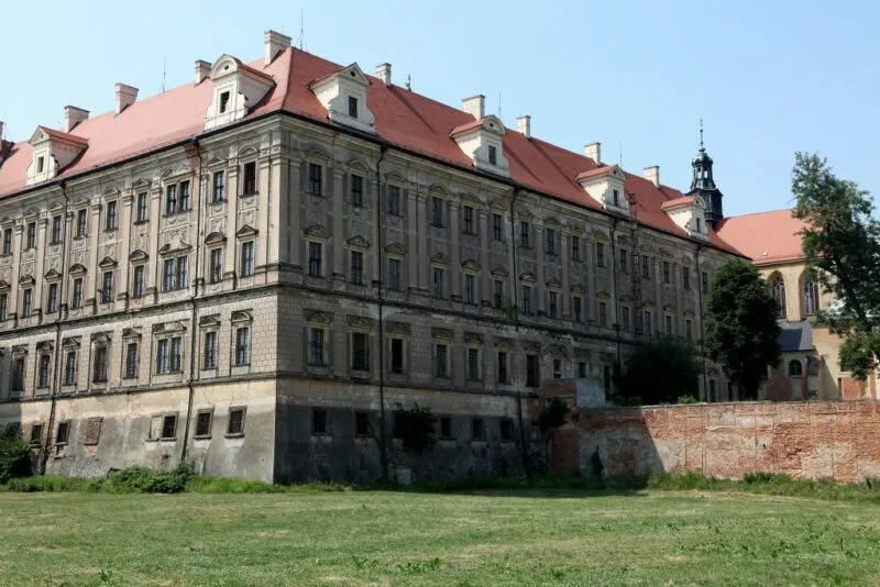 Zabytkowa barokowa budowla z wielkimi oknami z dachem w kolorze ceglanym